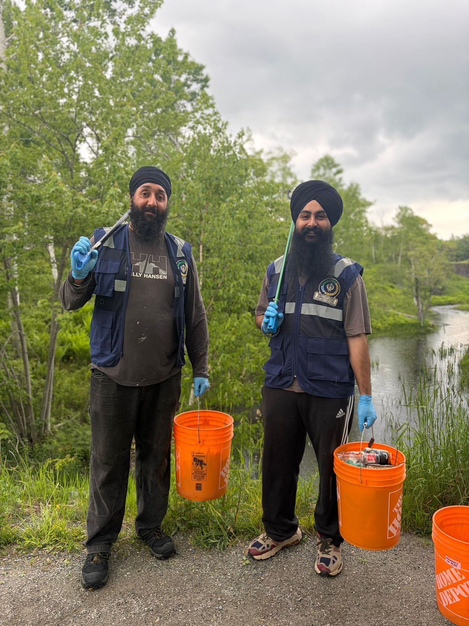BSA volunteers collecting litter along a riverside trail